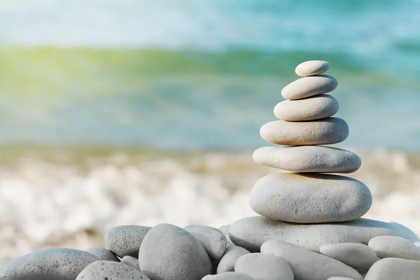 stacked rocks on a serene ocean